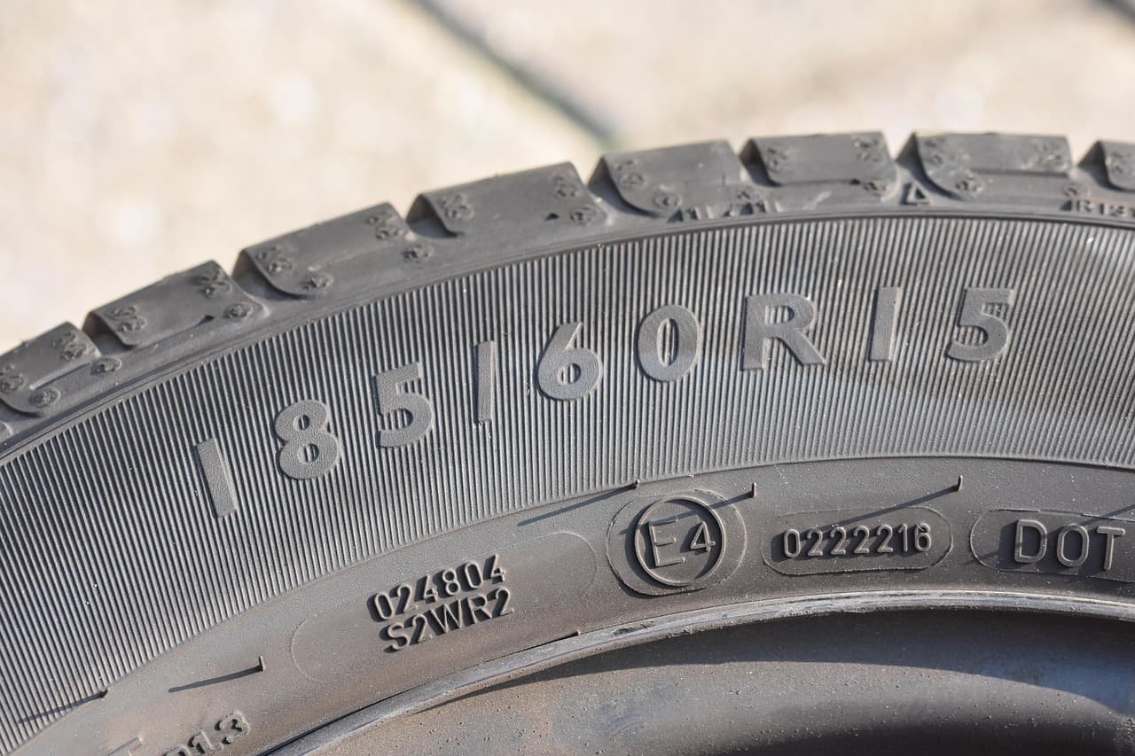 Close-up of a tyre sidewall showing the size code 185/60 R15